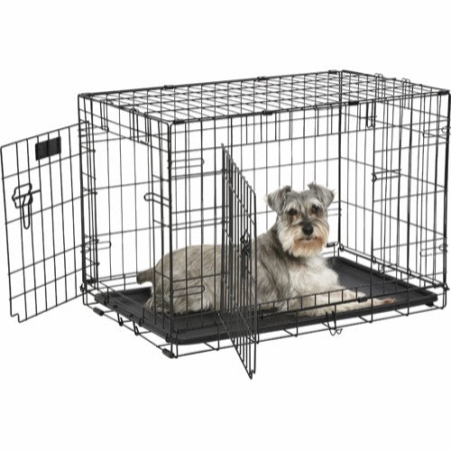 Beskrivelse: Et Trixie hundebur i sort med en grå hund indeni.